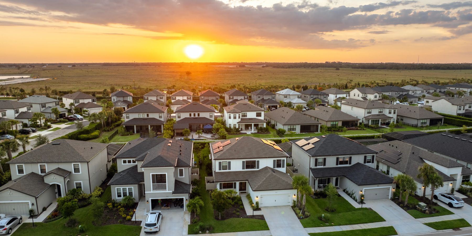 Aerial view of a single-family home subdivision at sunset